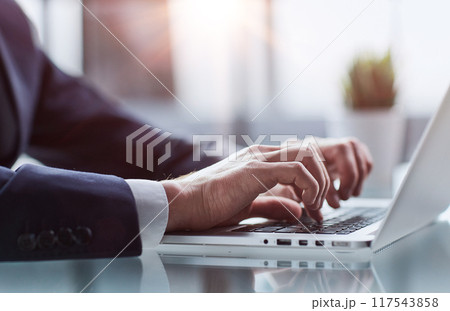 Closeup image of a man working and typing on laptop computer keyboard Closeup image of a man working and typing on laptop computer keyboard 117543858