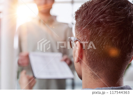 male accounting manager reviewing financial report, sitting at table alone at office male accounting manager reviewing financial report, sitting at table alone at office 117544363