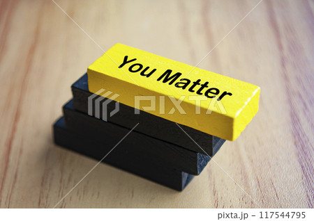 You matter text on yellow wooden block stacked on black wooden blocks. Inspirational concept. 117544795