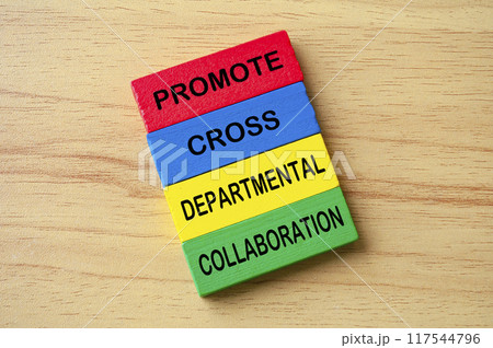 Top view of Promote Cross Departmental Collaboration text on multicolored wooden blocks. Business process improvement concept. Top view of Promote Cross Departmental Collaboration text on multicolored wooden blocks. Business process improvement concept. 117544796