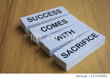 Angel view of Success Comes With Sacrifice text on white wooden blocks. Motivational and inspiration concept. Angel view of Success Comes With Sacrifice text on white wooden blocks. Motivational and inspiration concept. 117544802
