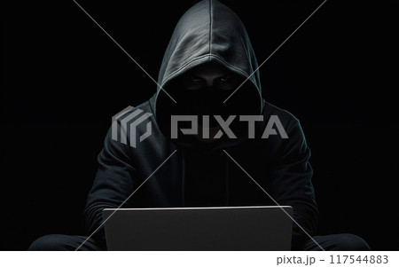 hacker, scammer, in a hoodie with his face covered in shadow, working with a laptop, cybersecurity 117544883