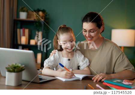 Girl doing homework or online education. 117545520