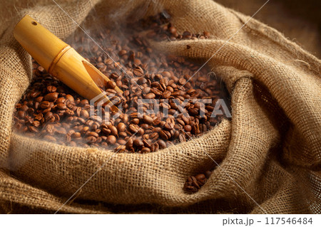 Fresh roasted coffee beans in burlap bag. Fresh roasted coffee beans in burlap bag. 117546484