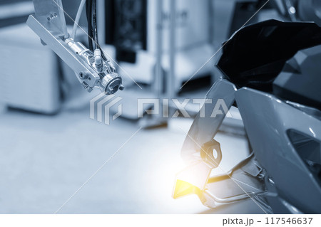 Close up scene the automatic painting robot working with automotive parts. 117546637