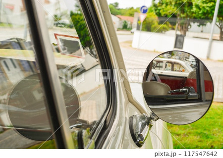 Close-up of a round mirror in a silver retro car with a pestle for signature on the mirror. Concept of love for luxury, old money style Close-up of a round mirror in a silver retro car with a pestle for signature on the mirror. Concept of love for luxury, old money style 117547642
