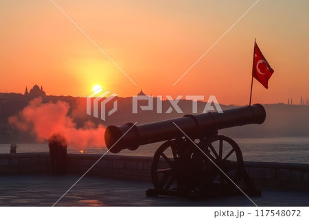 Historic cannon fires at dusk, Turkish flag waves as sun sets over city domes 117548072