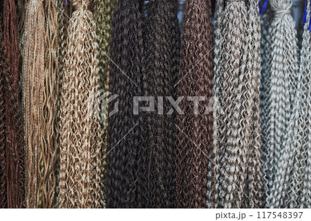 Artificial hair for braiding Afro-pigtails and hairstyles. Natural colors of zizi pigtails from kanekalon. Bright colors. Textured wallpaper. With space to copy. High quality photo Artificial hair for braiding Afro-pigtails and hairstyles. Natural colors of zizi pigtails from kanekalon. Bright colors. Textured wallpaper. With space to copy. High quality photo 117548397