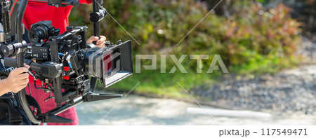 Movie shooting or video production and film crew team with camera equipment Movie shooting or video production and film crew team with camera equipment 117549471