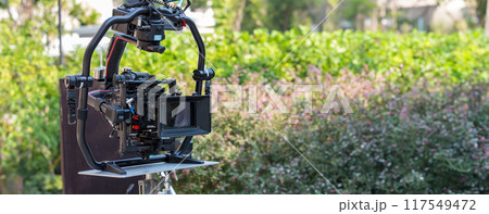 Movie shooting or video production and film crew team with camera equipment 117549472