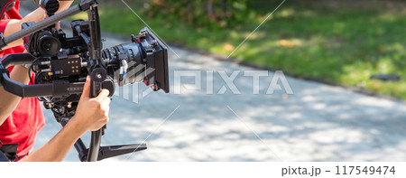 Movie shooting or video production and film crew team with camera equipment 117549474