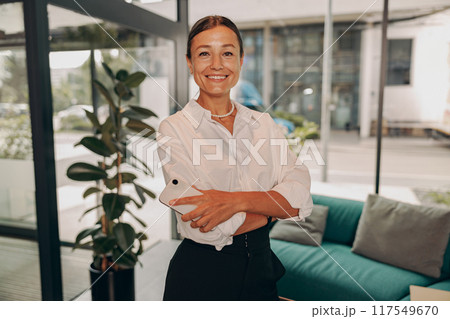 A Confident Businesswoman in a Contemporary Office Environment with Modern Touches A Confident Businesswoman in a Contemporary Office Environment with Modern Touches 117549670