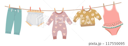 Toddler clothes drying. Child textile hanging on rope 117550095