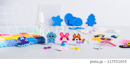 Children's toys made of aqua beads and a set for making on the table web banner Children's toys made of aqua beads and a set for making on the table web banner 117551055