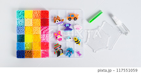 A box with aqua beads and tools for creating a decor top view web banner A box with aqua beads and tools for creating a decor top view web banner 117551059