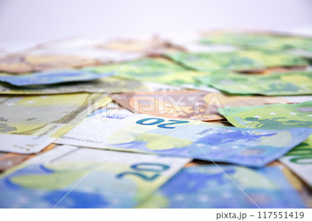 Close-up shot of several Euro banknotes, focusing on a twenty Euro note. The image captures the detail of the currency and its colors Close-up shot of several Euro banknotes, focusing on a twenty Euro note. The image captures the detail of the currency and its colors 117551419
