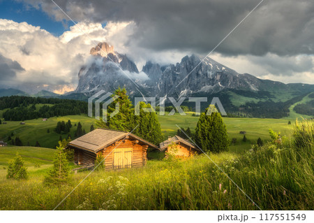 Colorful landscape with alpine mountains in low clouds and houses Colorful landscape with alpine mountains in low clouds and houses 117551549