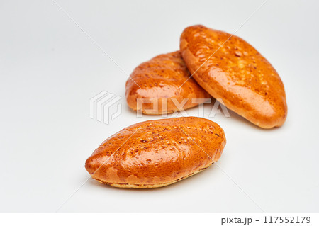 Golden-brown homemade pastries with a glossy crust, perfect for breakfast or a sweet snack 117552179