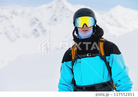 Handsome man smiling at ski resort, rider portrait. Happy tourist on vacation Handsome man smiling at ski resort, rider portrait. Happy tourist on vacation 117552851