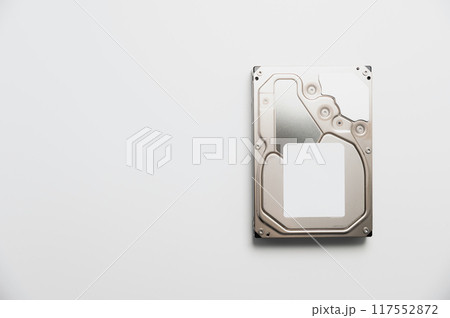 Disassembled interior of a hard drive, which is the computer's storage device. Broken hard drive on white background 117552872