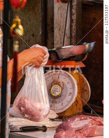 Meat Being Weighed at an Asian Market Meat Being Weighed at an Asian Market 117553197