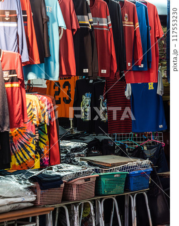 Colorful T-Shirts Hanging at a Market Stall Colorful T-Shirts Hanging at a Market Stall 117553230