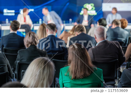 Audience attentively listening to business conference panel discussion 117553609