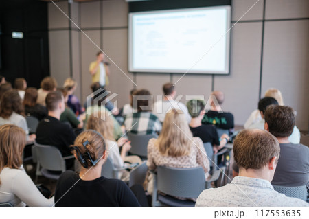 Audience at a business seminar attentively listening to a speaker 117553635