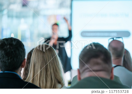 Audience listening to a business presentation in a conference room Audience listening to a business presentation in a conference room 117553728