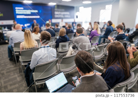 Business conference session with audience and panel discussion 117553736