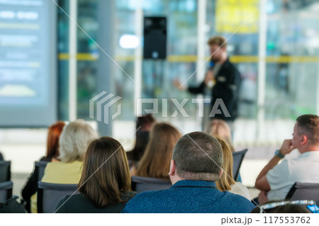 Speaker presenting at business conference with attentive audience Speaker presenting at business conference with attentive audience 117553762