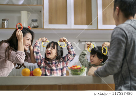 young asian family with two children having a good time in kitchen at home 117557480