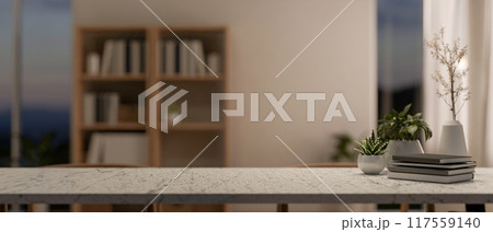 A textured stone tabletop featuring a copy space for displaying products in a contemporary room. A textured stone tabletop featuring a copy space for displaying products in a contemporary room. 117559140
