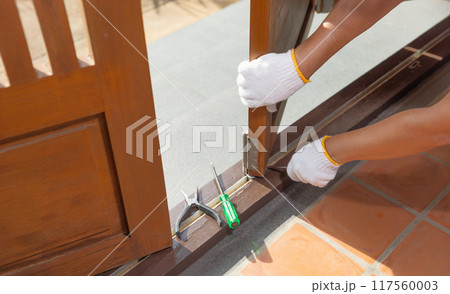 Handyman fixing bifold doors sticking or not sliding properly. Handyman fixing bifold doors sticking or not sliding properly. 117560003