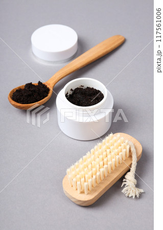 Coffee scrub for the body, in a white jar with a lid, on a gray background. 117561006