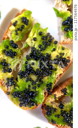 Gluten-free bread sandwiches with avocado and black caviar. Close-up, top view. Healthy eating 117564976