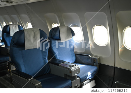 Airplane interior. Empty passenger seats in an airplane cabin Airplane interior. Empty passenger seats in an airplane cabin 117566215
