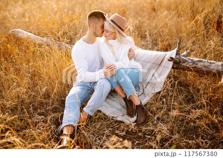 Young couple having fun walking and hugging n the park. Autumn weather. Relaxation, youth. 117567380