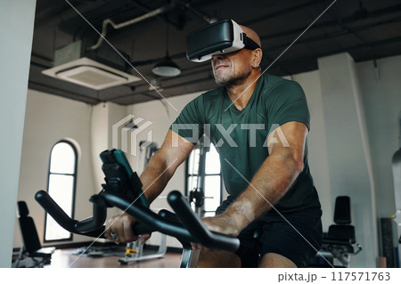 Man Exercising In VR Glasses In Gym 117571763