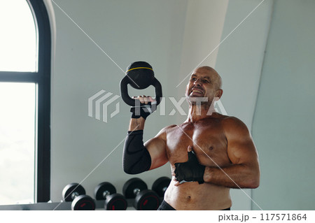 Man Lifting Weights In Gym Man Lifting Weights In Gym 117571864