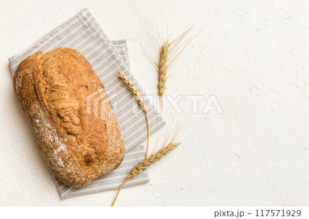 Fresh Homemade Whole Wheat Bread. bread on napkin on rustic background, fresh bread top view Fresh Homemade Whole Wheat Bread. bread on napkin on rustic background, fresh bread top view 117571929