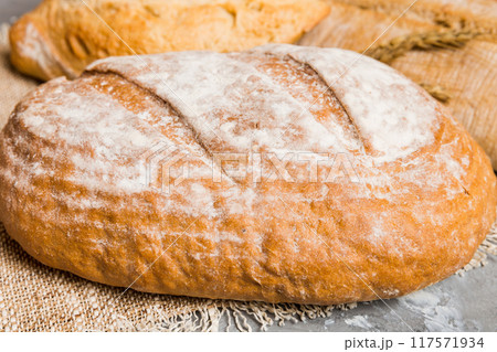 Homemade natural breads. Different kinds of fresh bread as background, perspective view with copy space Homemade natural breads. Different kinds of fresh bread as background, perspective view with copy space 117571934
