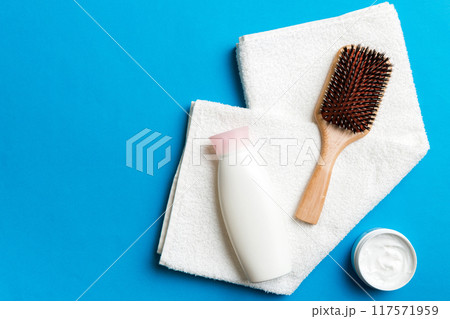 cosmetic for hair care, cream and towel on a colored background top view. flat lay cosmetic for hair care, cream and towel on a colored background top view. flat lay 117571959