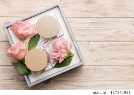 Composition with cosmetic products and beautiful roses on wooden background. Copy space, flat lay 117571981