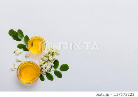 honey jar with acacia flowers and leaves. fresh honey top view flat lay honey jar with acacia flowers and leaves. fresh honey top view flat lay 117572122