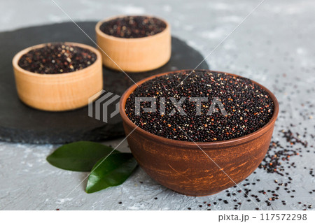 quinoa seeds in bowl on colored background. Healthy kinwa in small bowl. Healthy superfood 117572298