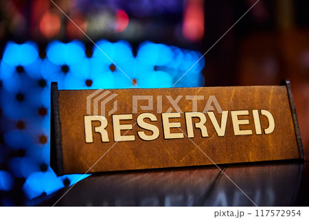 Sign with the inscription Reserved on the restaurant table Sign with the inscription Reserved on the restaurant table 117572954