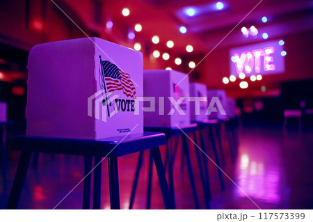 Empty polling station with row of white voting booths decorated with American flag at vote center. Presidential American elections in the United States. Democracy and election day concept 117573399