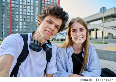 Portrait of young students guy and girl, outdoors together Portrait of young students guy and girl, outdoors together 117574587