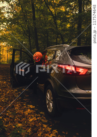 halloween concept man with pumpkin head in suv car halloween concept man with pumpkin head in suv car 117574648